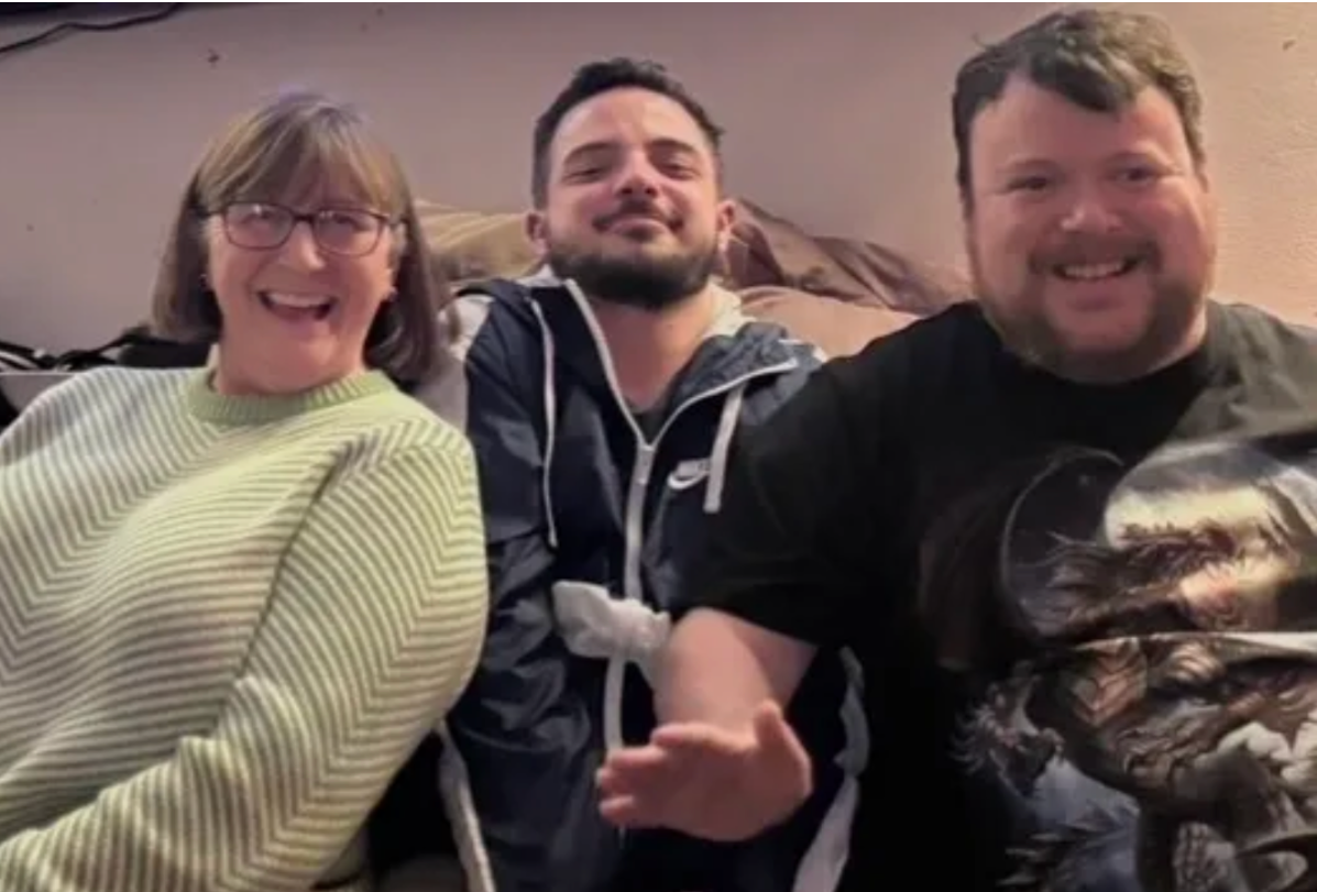 Three community members laughing together at a social event