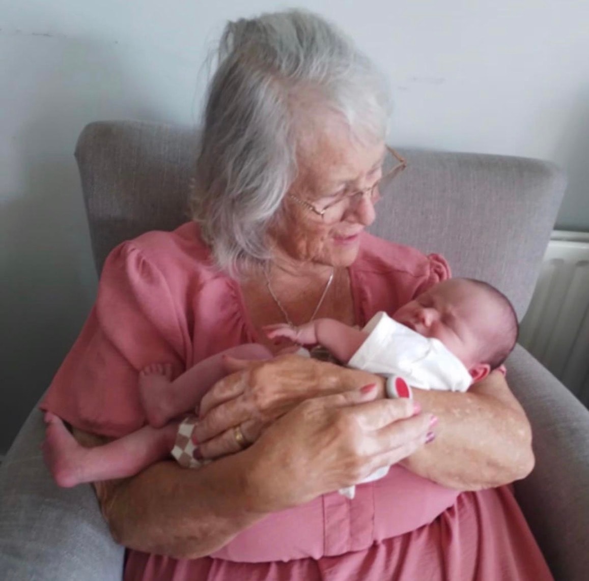 Grandmother tenderly holding a newborn baby