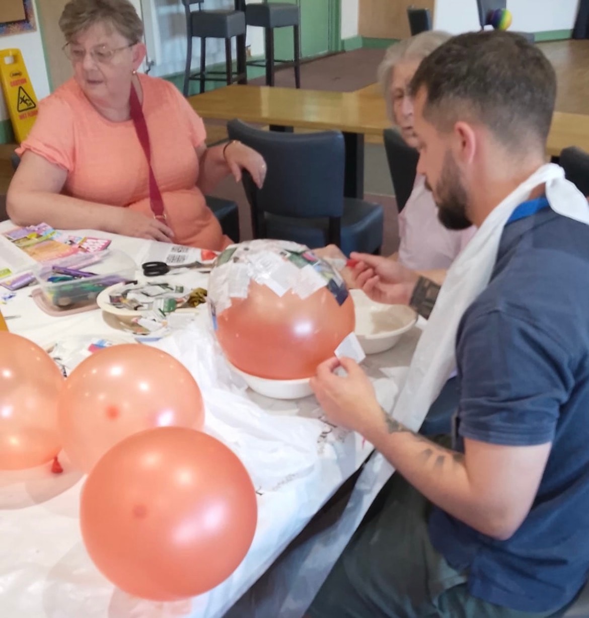 Group craft session — papier-mâché with balloons